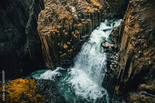 A different perspective on famous Litlanesfoss waterfall near Hengifoss, in eastern Iceland. photo