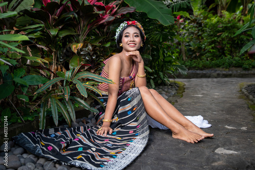 Принти на полотні Young asian female Bare Feet Relaxing dressed in colorful costumes in a botanica
