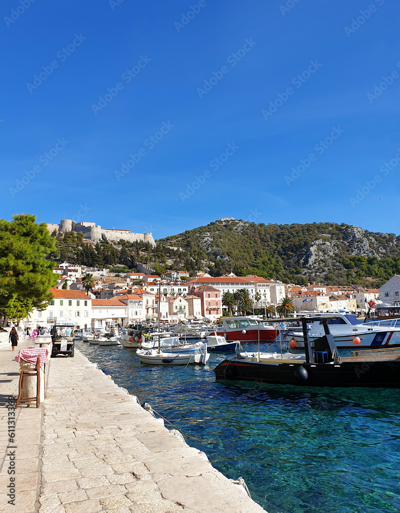Fototapeta premium scenic view of boats in harbor against clear blue sky at Hvar, Croatia