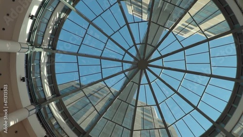 Top view of the curved roof of a fantasy office building. Modern and contemporary architectural fiction with glass steel column. Glass dome and sun. Top view of a glass structure