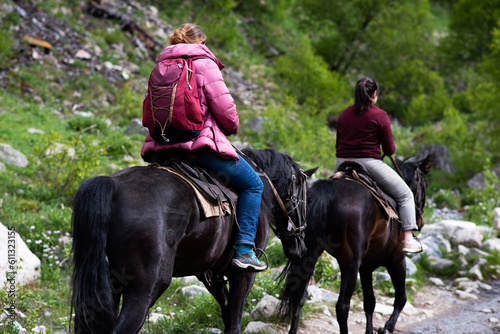 Horse riding. A group of people riding horses on a mountain trail.