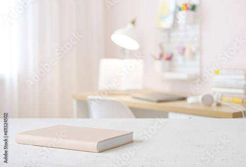 Book on table with blurred teenager room background