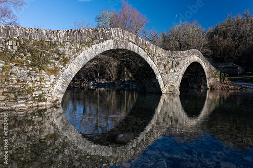 View of the traditional stone Mylos Bridge in Zagori of Epirus, Greece. photo