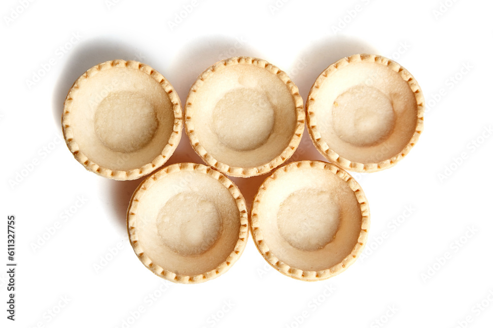 Tartlet shells isolated on white background, top view. Empty mini tart shells for portable desserts Tartlet shells isolated on white background, top view. Empty mini tart shells for portable desserts