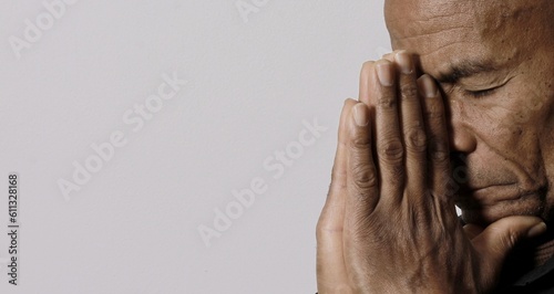 man praying to god with hands together Caribbean man praying on black background with people stock photos stock photo 