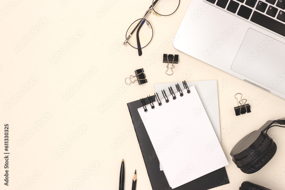 Layout with laptop, eyeglasses and stationery on a beige background. E-learning concept with place for text. Layout with laptop, eyeglasses and stationery on a beige background. E-learning concept with place for text.