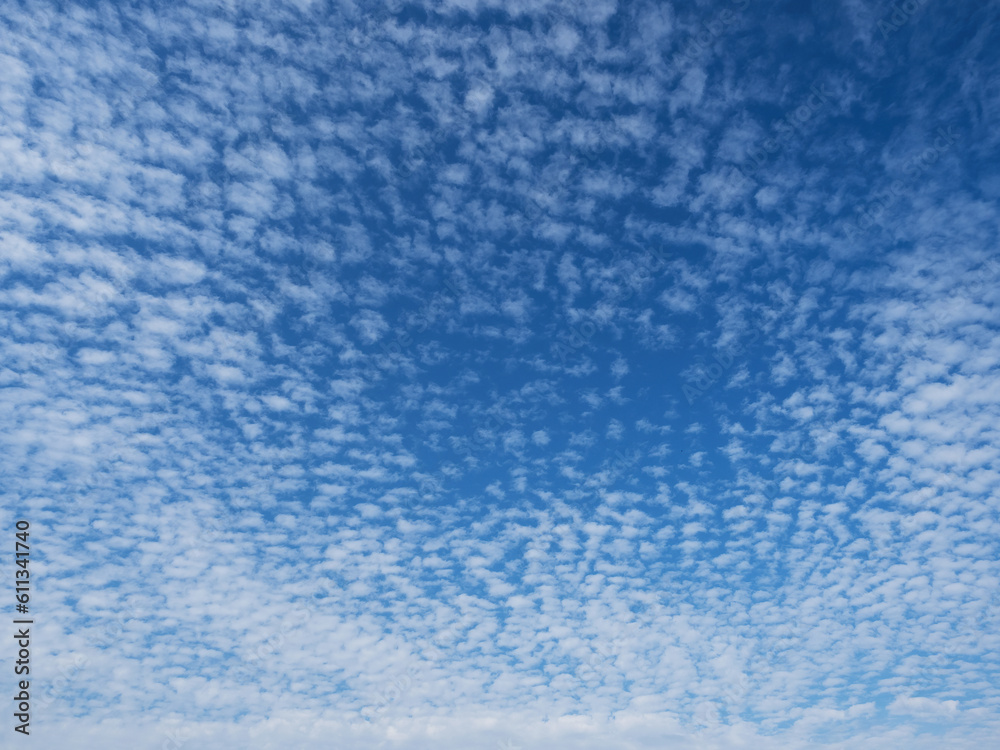 Blue sky with unusual abstract white clouds structure. Strange dramatic clouds pattern texture. Blue sky with unusual abstract white clouds structure. Strange dramatic clouds pattern texture.
