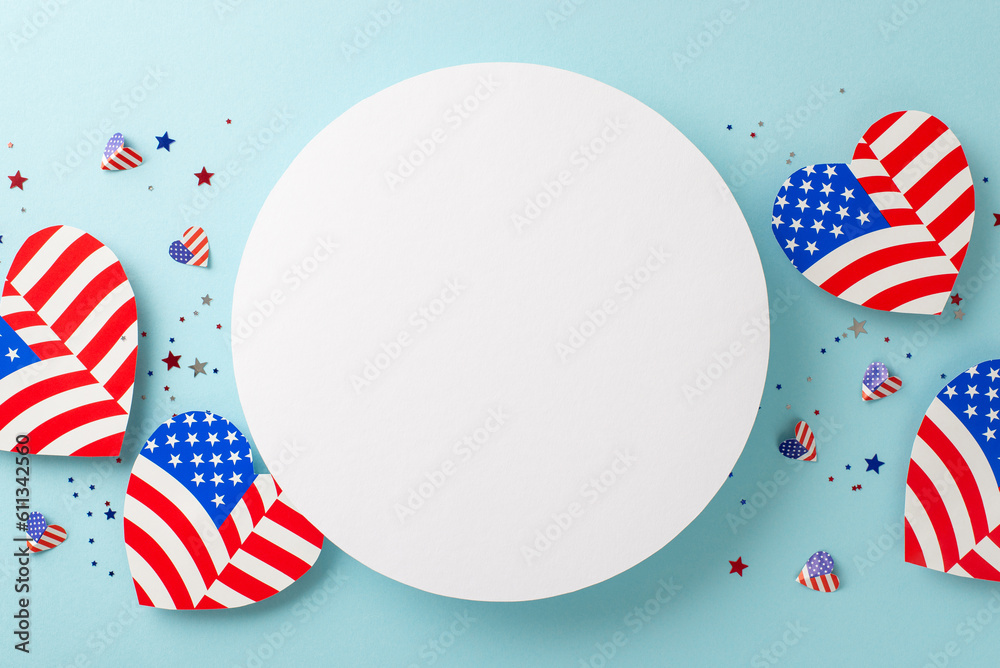 Obraz premium Memorial Day festivity. From above, observe symbolic embellishments: American flag patterned hearts, and confetti, placed on a pastel blue surface with an empty circle for text or promotion