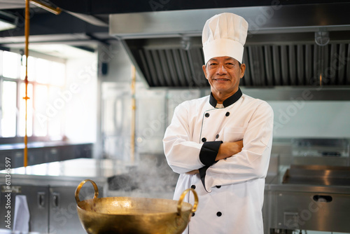 Experienced chef is cooking in a large kitchen in a famous restaurant.