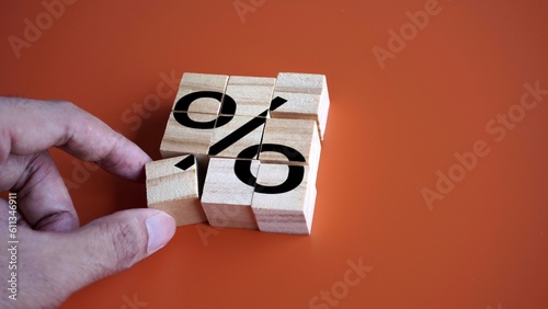 Hand arrange wooden cubes with percentage sign. Debt restructuring, loan refinancing and pay off debts concept photo