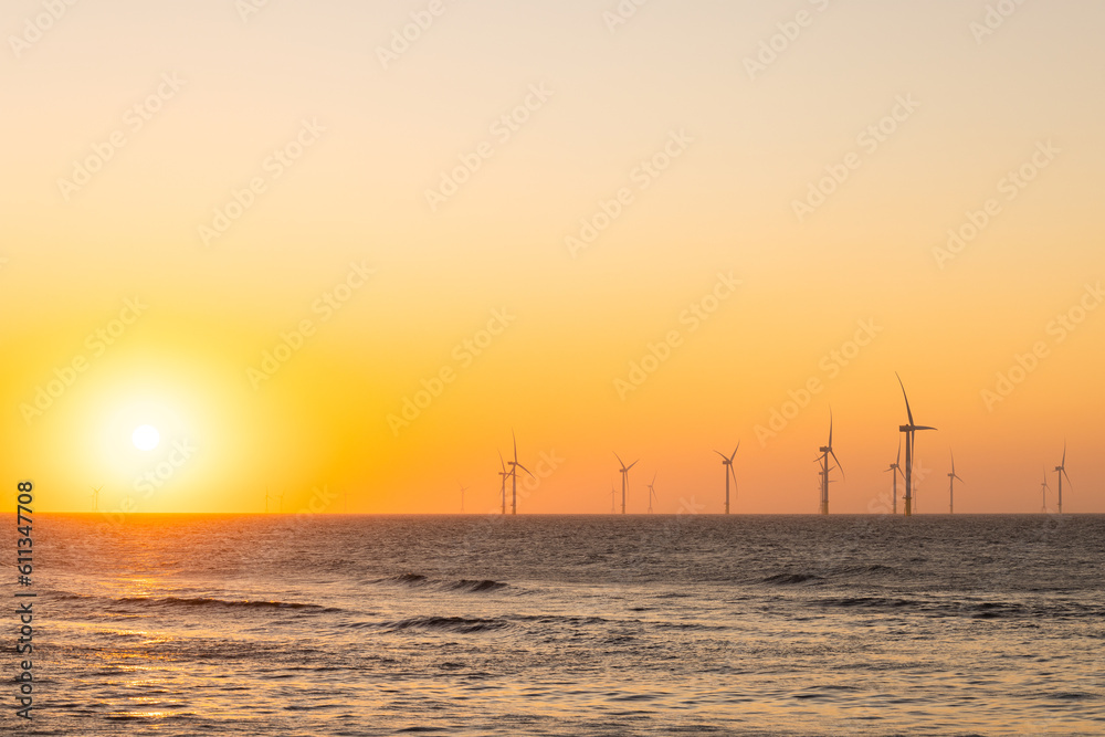 Wind turbine field over the sea in the evening