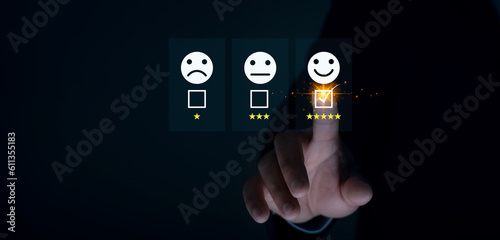 Businessman touching and check mark icon face emoticon smile on black background; service mind; service rating. Satisfaction and customer service concept.