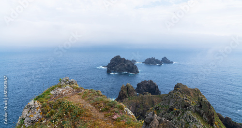 View of the Atlantic coast near the Cabo Ortegal lighthouse on the coast of Galicia, Spain, Europe. Flowering spring coastal plants. Majestic coastline looking the Atlantic Ocean. photo