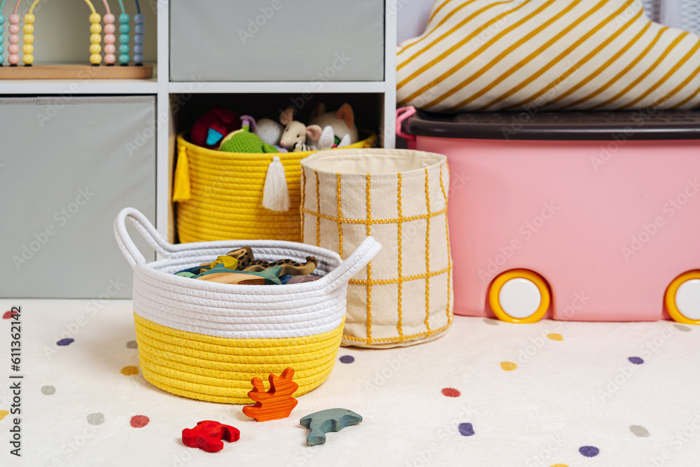 Children room with shelves and colorful storage baskets and boxes