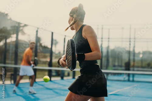 Female athlete dominating the padel court in competitive match