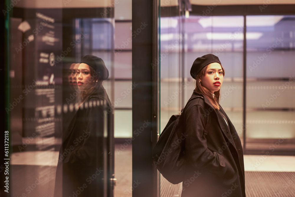 Young woman wearing black hat standing at the tram station and looking distance Young woman wearing black hat standing at the tram station and looking distance