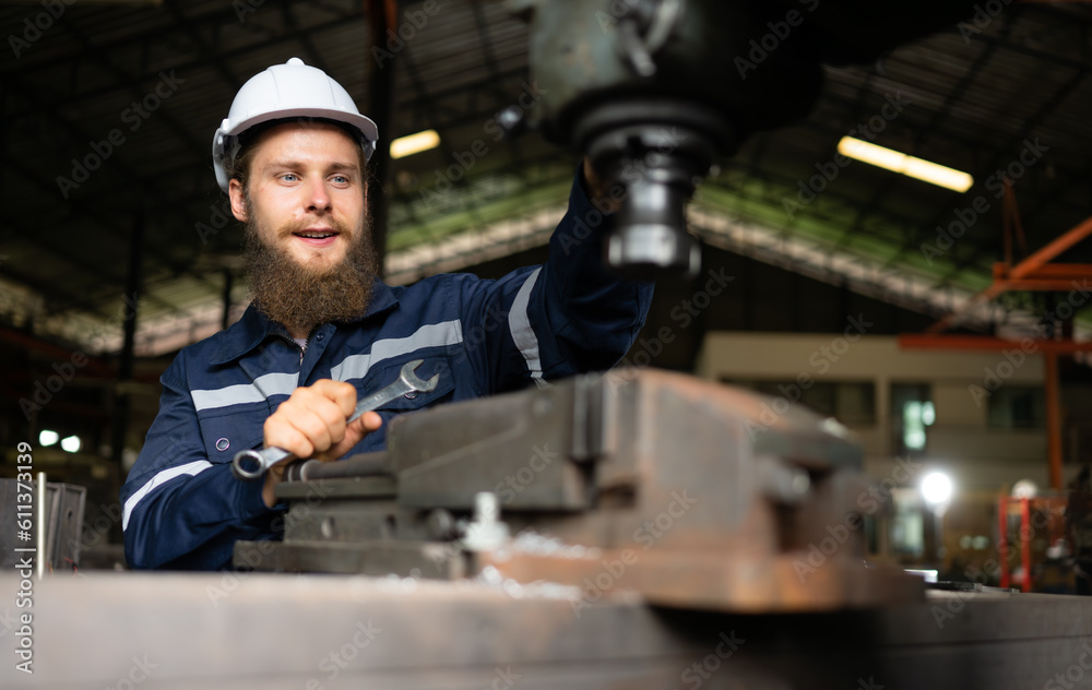 Portrait of mechanical engineers are checking the working condition of an old machine that has been used for some time. In a factory where natural light shines onto the workplace Portrait of mechanical engineers are checking the working condition of an old machine that has been used for some time. In a factory where natural light shines onto the workplace