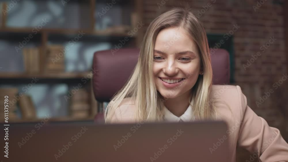 Close up of gorgeous long-haired woman checking tender results on personal laptop and winning. Cheerful female showing victory gesture and raising arm in excitement. Concept of sincere emotions. Close up of gorgeous long-haired woman checking tender results on personal laptop and winning. Cheerful female showing victory gesture and raising arm in excitement. Concept of sincere emotions.