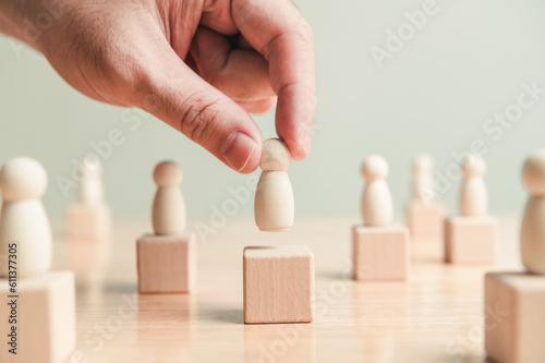 Hand placing officer job employee career position on wooden block wood cube stage background. Management business strategy concept. Human resource recruitment theme. Opportunity ranking chance team photo