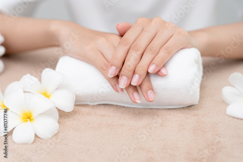 Woman show beautiful nail after receive care service by professional Beautician Manicure at spa centre. Nail beauty salon use nail file for Glazing treatment. manicurist make nail to beautiful.