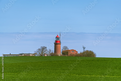 Lighthouse Buk On A Green Hill