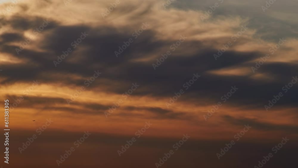 The spectacular view of the sunset was breathtaking, with the sun sinking behind the clouds on the horizon.