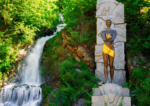 Monument to Prometheus near a waterfall in Borjomi Park, Borjomi Georgia. photo