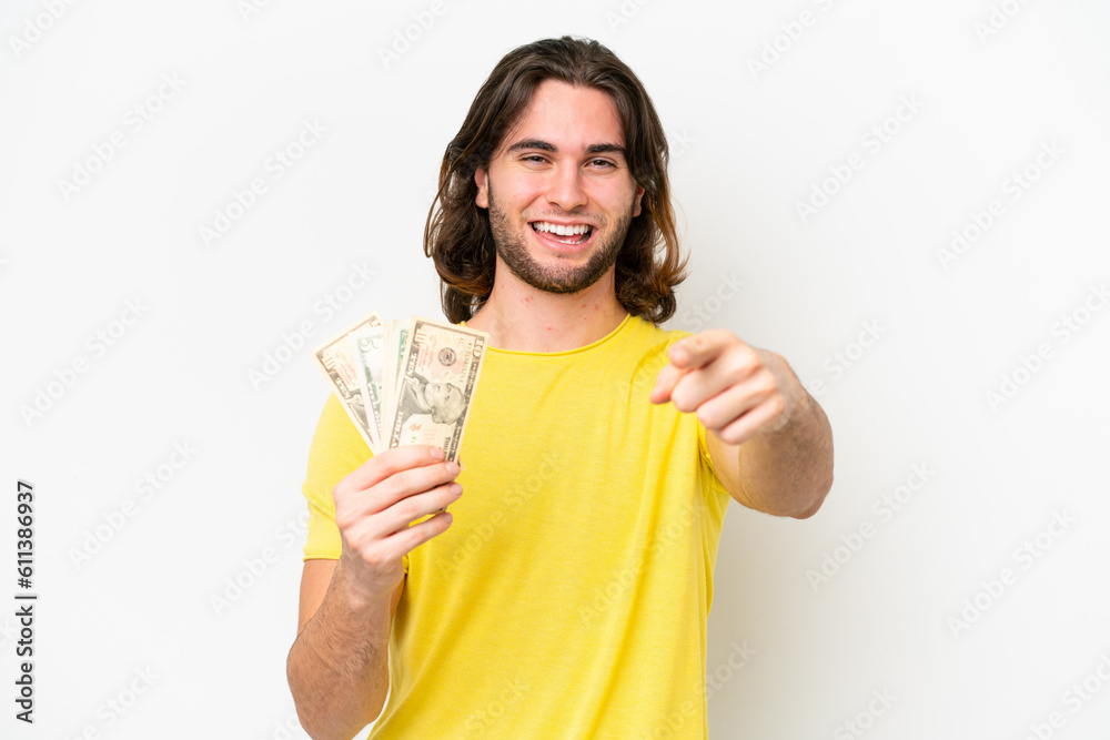 Young handsome man taking a lot of money isolated on white background points finger at you with a confident expression Young handsome man taking a lot of money isolated on white background points finger at you with a confident expression