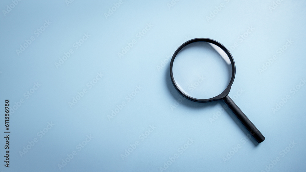 Top view empty lens black magnifying glass on white blue pastel background. Flat lay object and inspection investigate science equipment tool concept. Police and Ciencia forense theme. Copy space. Top view empty lens black magnifying glass on white blue pastel background. Flat lay object and inspection investigate science equipment tool concept. Police and Ciencia forense theme. Copy space.