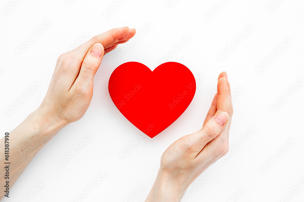 Medical and health care concept - heart with female hands Medical and health care concept - heart with female hands