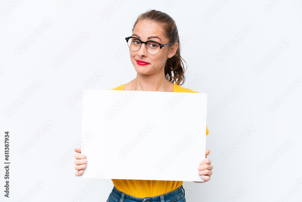 Young caucasian woman isolated on white background holding an empty placard Young caucasian woman isolated on white background holding an empty placard