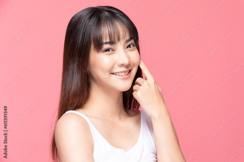 Young Beautiful Asian woman smile touching soft cheek with clean and fresh skin Happiness and cheerful with positive emotional,isolated on pink background,Beauty Cosmetics and spa Treatment Concept Young Beautiful Asian woman smile touching soft cheek with clean and fresh skin Happiness and cheerful with positive emotional,isolated on pink background,Beauty Cosmetics and spa Treatment Concept