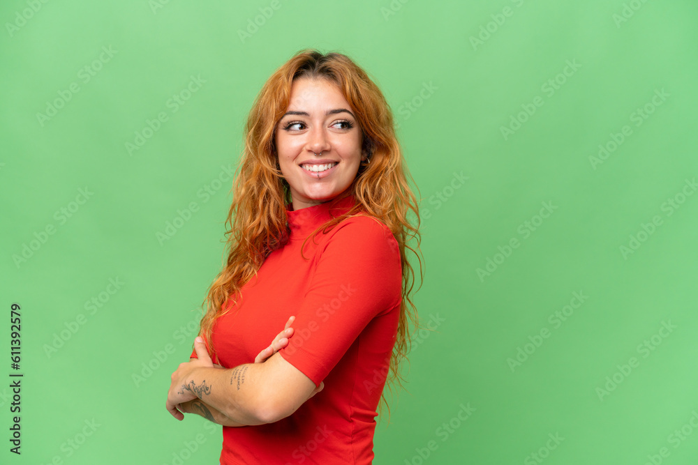 Young caucasian woman isolated on green screen chroma key background with arms crossed and happy Young caucasian woman isolated on green screen chroma key background with arms crossed and happy