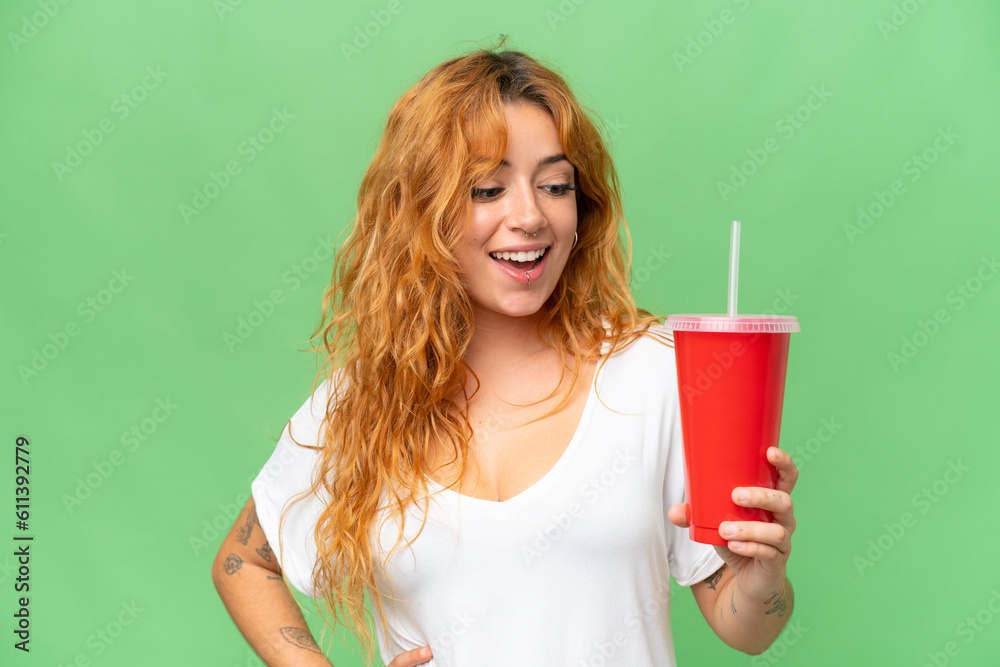 Young caucasian woman holding soda isolated on green screen chroma key background Young caucasian woman holding soda isolated on green screen chroma key background