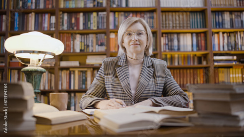 Portrait of a senior woman librarian working late, occupation, scientific research