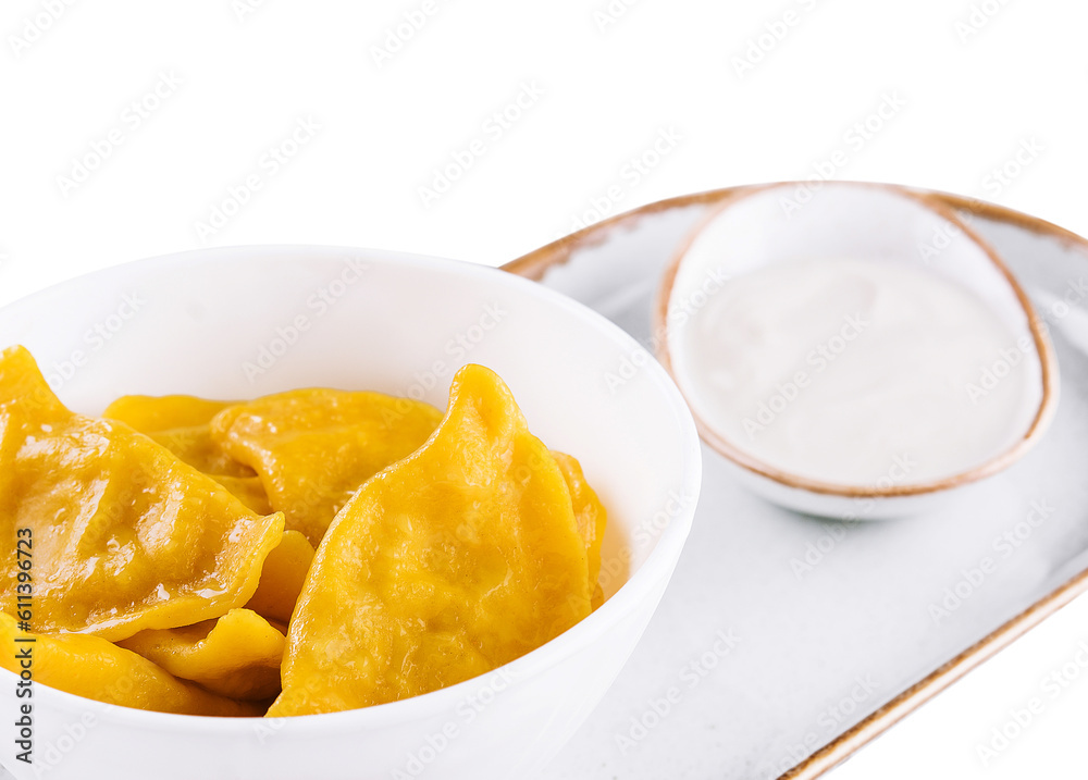 Tasty dumplings in bowl with sour cream