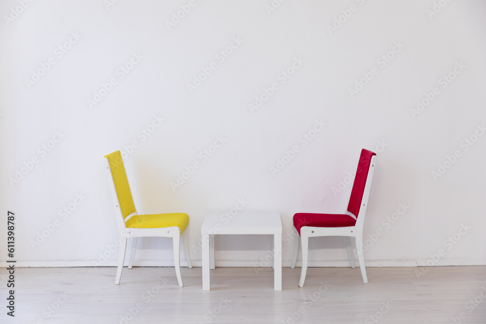 Fototapeta premium chairs yellow and red coffee table in a bright room