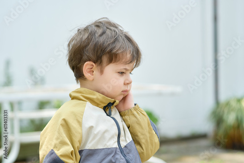curious young boy exploring the backyard on a sunny day