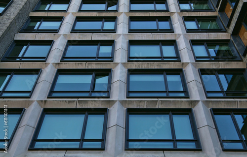 tall residential building detail (windows, lines, symmetry, asymmetry) looking up at closed and open windows, juliet balcony