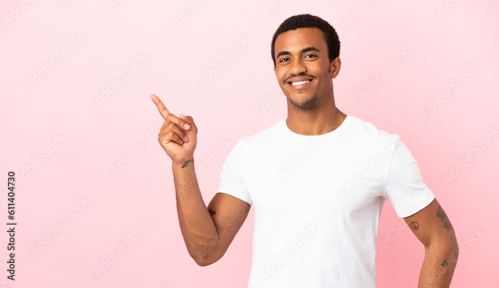 African American man on copyspace pink background showing and lifting a finger in sign of the best African American man on copyspace pink background showing and lifting a finger in sign of the best