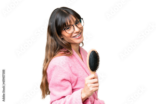 Young woman with hair comb over isolated chroma key background smiling a lot