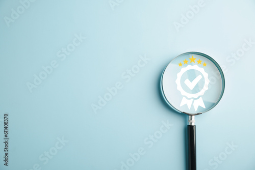 Magnifying glass reveals an aligned icon, symbolizing quality assurance certificate. Emphasizing the importance of certification and ISO quality concept for confidence in good service. photo