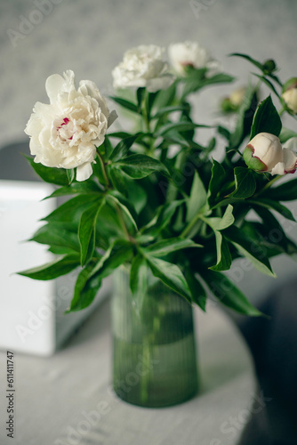 Fototapeta Naklejka Na Ścianę i Meble -  Fresh white fragrant peonies on the background of a home interior