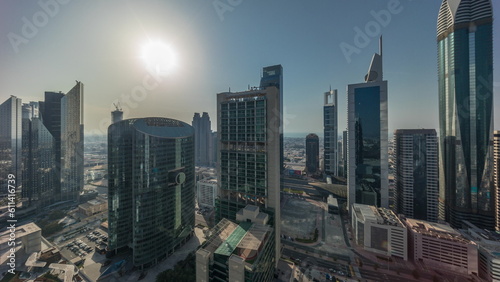 Dubai international financial center skyscrapers with cloudy blue sky aerial all day timelapse.