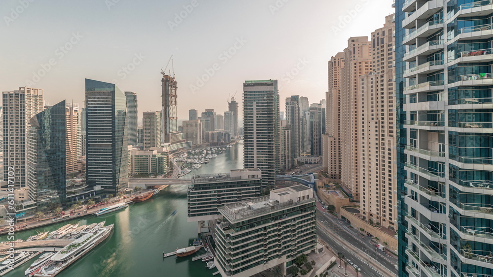 Obraz premium Panorama showing overview to JBR and Dubai Marina skyline with modern high rise skyscrapers waterfront living apartments aerial timelapse