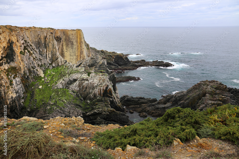 Beautiful cliffs of Sardao Cape with white storks