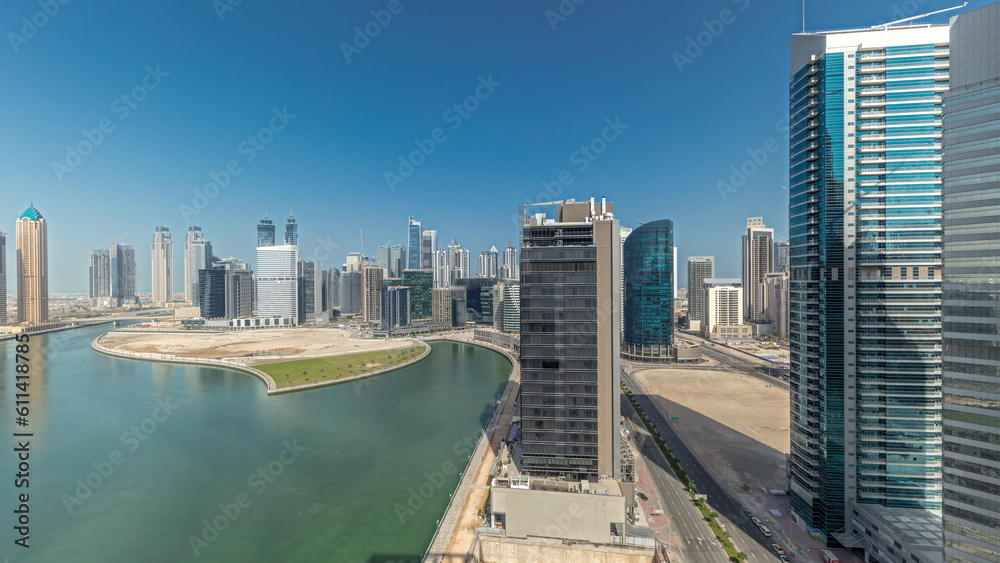 Cityscape skyscrapers of Dubai Business Bay with water canal aerial timelapse.