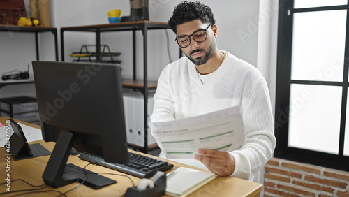 African american man business worker using computer reading document at office