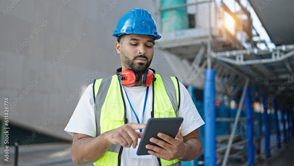 African american man builder using touchpad at street African american man builder using touchpad at street