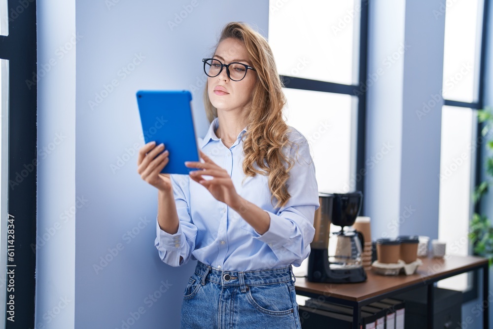 Young blonde woman business worker using touchpad at office Young blonde woman business worker using touchpad at office